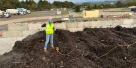 engineer inspecting compost pile